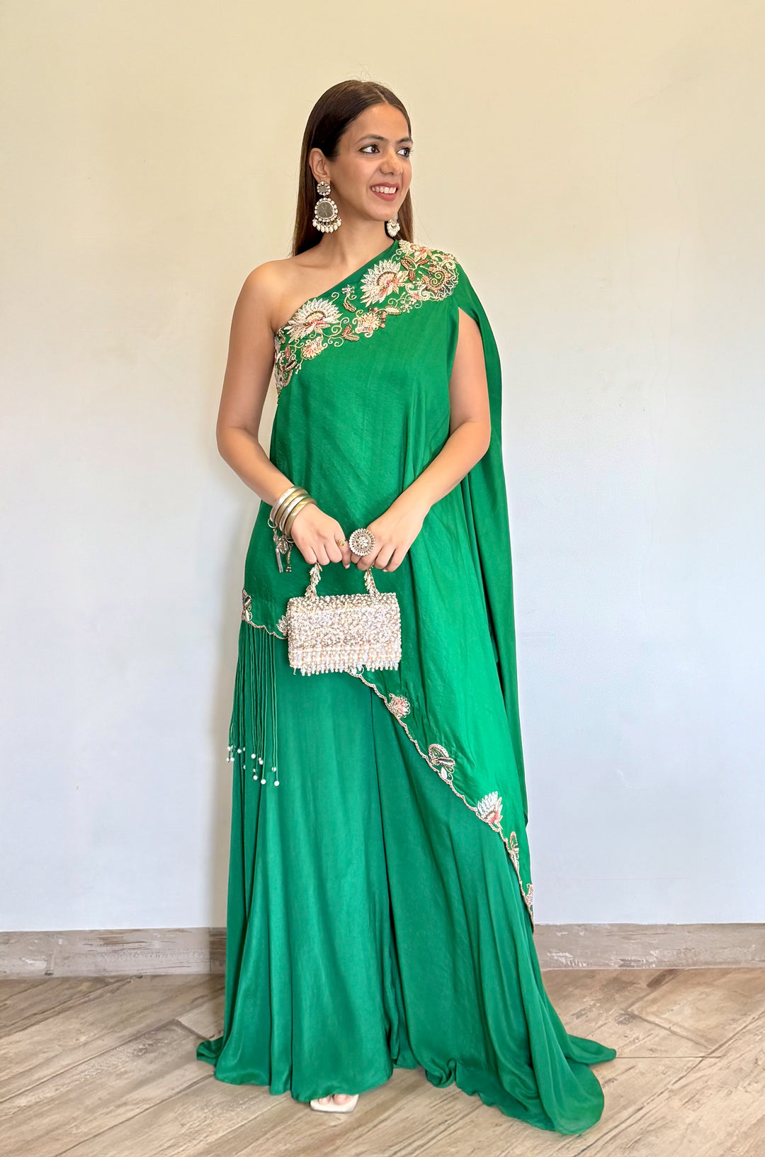 SIGNATURE HAND EMBROIDERED ONE SHOULDER DRAPE SET. PAIRED WITH FLARED PANTS.